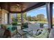 Relaxing covered patio with wicker furniture overlooking a beautiful pool and backyard area with a stone fireplace at 8724 Highgrove St, Charlotte, NC 28277