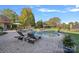 Serene pool area featuring lounge chairs, a small waterfall feature, and lush landscaping; perfect for outdoor enjoyment at 8724 Highgrove St, Charlotte, NC 28277