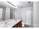 Bright bathroom featuring double vanity, framed mirror, updated fixtures, and a shower-tub combination at 10114 Turkey Point Dr, Charlotte, NC 28214
