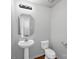 A cozy half-bathroom with a pedestal sink and white fixtures at 10114 Turkey Point Dr, Charlotte, NC 28214