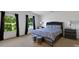 Inviting bedroom features large windows, neutral walls, and modern bedroom set at 10114 Turkey Point Dr, Charlotte, NC 28214