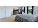 Serene bedroom with large windows, neutral carpet, and modern furnishings at 10114 Turkey Point Dr, Charlotte, NC 28214