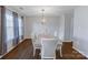 Formal dining room featuring hardwood floors, a contemporary light fixture, and backyard views at 10114 Turkey Point Dr, Charlotte, NC 28214