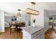 Open-concept dining area with modern light fixtures and a view into the spacious living room at 10114 Turkey Point Dr, Charlotte, NC 28214