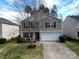 Charming two-story home featuring a well-manicured lawn and a convenient two-car garage at 10114 Turkey Point Dr, Charlotte, NC 28214