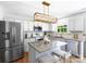 Bright kitchen features stainless steel appliances, granite countertops, and island with seating at 10114 Turkey Point Dr, Charlotte, NC 28214