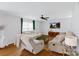 Bright living room featuring hardwood floors, a ceiling fan, and plush furniture at 10114 Turkey Point Dr, Charlotte, NC 28214