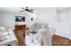 Bright living room with hardwood floors, ceiling fan, and cozy furniture arrangement at 10114 Turkey Point Dr, Charlotte, NC 28214