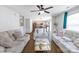 Spacious living room features wood floors, a ceiling fan, and a view into the modern kitchen at 10114 Turkey Point Dr, Charlotte, NC 28214
