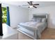 Stylish main bedroom with a ceiling fan, a large window, and a decorative bed frame at 10114 Turkey Point Dr, Charlotte, NC 28214