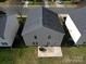 Aerial view of the rear exterior showcasing a backyard, patio and well maintained yard at 10114 Turkey Point Dr, Charlotte, NC 28214