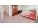 Cozy bedroom with neutral carpet, a comfortable bed, and antique wood furnishings at 105 Abel Peterson Dr, Mount Holly, NC 28120