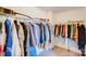 Spacious walk-in closet providing ample storage with a guitar on the top shelf at 105 Abel Peterson Dr, Mount Holly, NC 28120