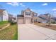 The home features a two car garage and long driveway at 105 Abel Peterson Dr, Mount Holly, NC 28120