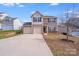 Neutral siding and a two-car garage highlight this two-story home at 105 Abel Peterson Dr, Mount Holly, NC 28120