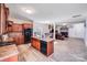 Inviting kitchen featuring wood cabinets, black appliances, kitchen island with sink, and an open layout at 105 Abel Peterson Dr, Mount Holly, NC 28120