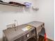 Bright laundry room with modern washer and dryer, plus convenient overhead shelving at 105 Abel Peterson Dr, Mount Holly, NC 28120