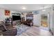 Open living room with leather sofas, a large TV, built-in shelving, and unique wall decorations at 105 Abel Peterson Dr, Mount Holly, NC 28120