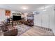 Spacious living room features hardwood floors, leather sofas, TV entertainment center and stylish decor at 105 Abel Peterson Dr, Mount Holly, NC 28120