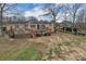 Spacious backyard with an expansive deck and mature trees surrounding the house at 107 Pinelake Dr, Kings Mountain, NC 28086