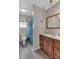 Bathroom with wooden vanity and contrasting nautical shower curtain at 107 Pinelake Dr, Kings Mountain, NC 28086