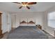 Bright bedroom boasts a decorative wooden headboard and a ceiling fan at 107 Pinelake Dr, Kings Mountain, NC 28086