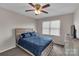 Cozy bedroom featuring a ceiling fan, natural light, and comfortable bedding at 107 Pinelake Dr, Kings Mountain, NC 28086