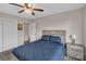 Relaxing bedroom with light colored wooden frame bed, ceiling fan and adjacent closet at 107 Pinelake Dr, Kings Mountain, NC 28086