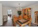 Well-lit dining room with a wooden table set, chandelier, and hutch for displaying fine china at 107 Pinelake Dr, Kings Mountain, NC 28086