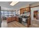 Galley kitchen featuring a granite counter, stainless steel appliances and view into the dining area at 107 Pinelake Dr, Kings Mountain, NC 28086