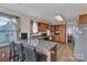 The kitchen features granite counters, wood cabinets, island with seating, and stainless appliances at 107 Pinelake Dr, Kings Mountain, NC 28086