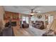 Cozy living room with brick fireplace, wood paneling, and comfortable seating, creating a warm atmosphere at 107 Pinelake Dr, Kings Mountain, NC 28086