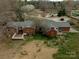 Aerial view showcasing a brick home with deck and patio, surrounded by a yard with potential at 10843 Caroline Acres Rd, Fort Mill, SC 29707