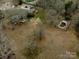 An aerial view displaying the home's setting near a pool, gazebo, and pond at 10843 Caroline Acres Rd, Fort Mill, SC 29707