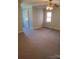 Bedroom features carpet, neutral walls, ceiling fan, and bright natural light from a window at 10843 Caroline Acres Rd, Fort Mill, SC 29707