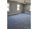 Spacious bedroom with carpet, neutral walls, ceiling fan, and bright natural light from three windows at 10843 Caroline Acres Rd, Fort Mill, SC 29707