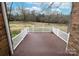 A spacious deck with white railings overlooks a large, grassy yard at 10843 Caroline Acres Rd, Fort Mill, SC 29707