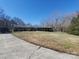 Spacious brick home with a long driveway and well-maintained lawn on a sunny day at 10843 Caroline Acres Rd, Fort Mill, SC 29707
