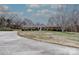 A long driveway leads up to a brick ranch house with well-kept landscaping at 10843 Caroline Acres Rd, Fort Mill, SC 29707