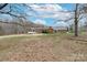 A home sits surrounded by leafless trees on a large, grassy lot at 10843 Caroline Acres Rd, Fort Mill, SC 29707