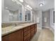 Bright bathroom with double sinks, granite countertops, modern lighting, and a walk-in shower at 1122 Hartmann Ct, Fort Mill, SC 29715