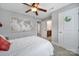 Bright bedroom featuring a ceiling fan, access to a bathroom, and charming decor at 1122 Hartmann Ct, Fort Mill, SC 29715