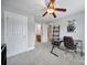 Well-lit bedroom with gray walls, ceiling fan, and a desk for a functional workspace at 1122 Hartmann Ct, Fort Mill, SC 29715