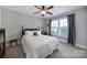 Comfortable bedroom with neutral paint, wood-look ceiling fan, and large window with curtains at 1122 Hartmann Ct, Fort Mill, SC 29715