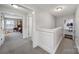 Upstairs hallway featuring neutral walls and carpet, providing access to bedrooms at 1122 Hartmann Ct, Fort Mill, SC 29715