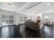 Bright living room featuring hardwood floors, a ceiling fan, and an indoor fireplace with sliding glass doors at 1122 Hartmann Ct, Fort Mill, SC 29715