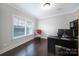 Well-lit office space with wood floors, modern desk, and view of backyard through window at 1122 Hartmann Ct, Fort Mill, SC 29715