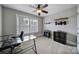 Bedroom staged as office with large window, black rolling chair, black desk and black storage cabinet at 1122 Hartmann Ct, Fort Mill, SC 29715