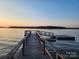 Picturesque view of a wooden dock extending into the tranquil lake at sunset at 120 Ole Point Ln, Salisbury, NC 28146