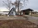 Charming A-frame house with gray siding, white trim, a covered parking area, and lake access at 120 Ole Point Ln, Salisbury, NC 28146
